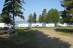 Photo showing RV campground and camping sites.